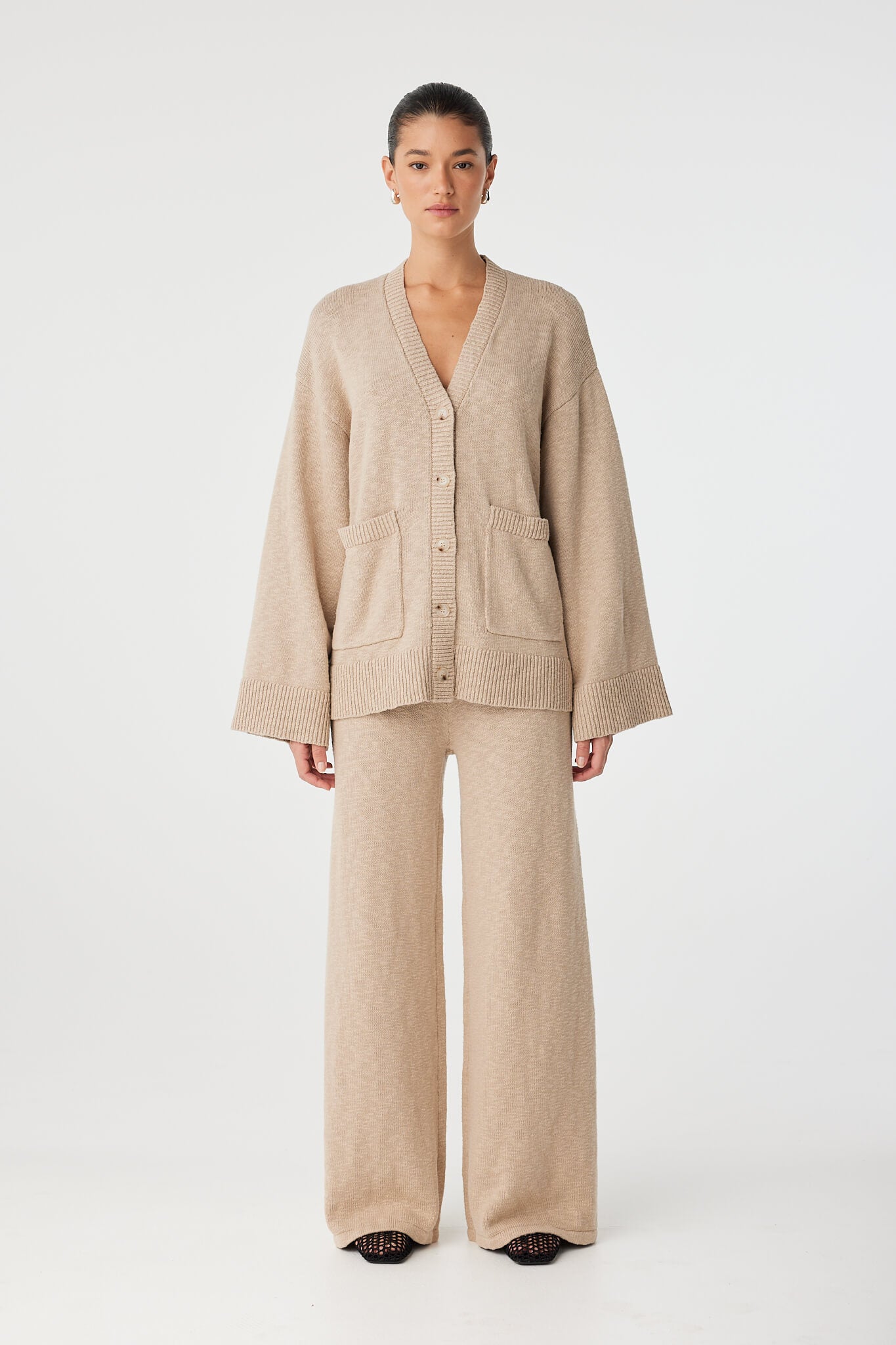Full look: taupe slub knit cardigan and matching pants in organic cotton, styled for effortless layering.