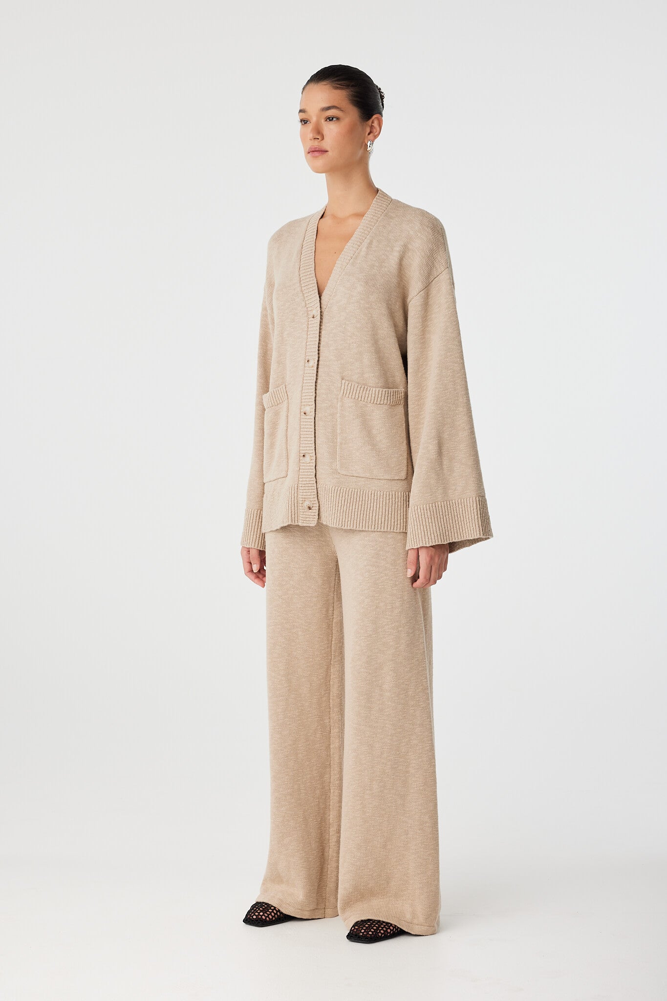 Side view of relaxed-fit cardigan in textured slub cotton, showing sleeve volume and clean drape.