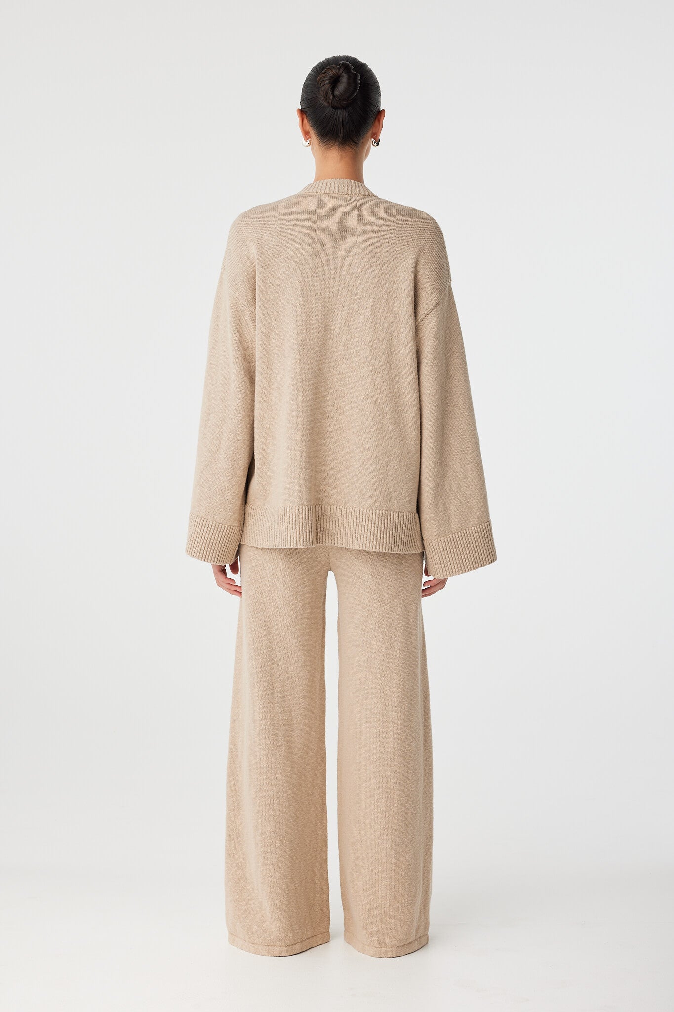 Back view of taupe longline cardigan with dropped shoulders and natural drape.