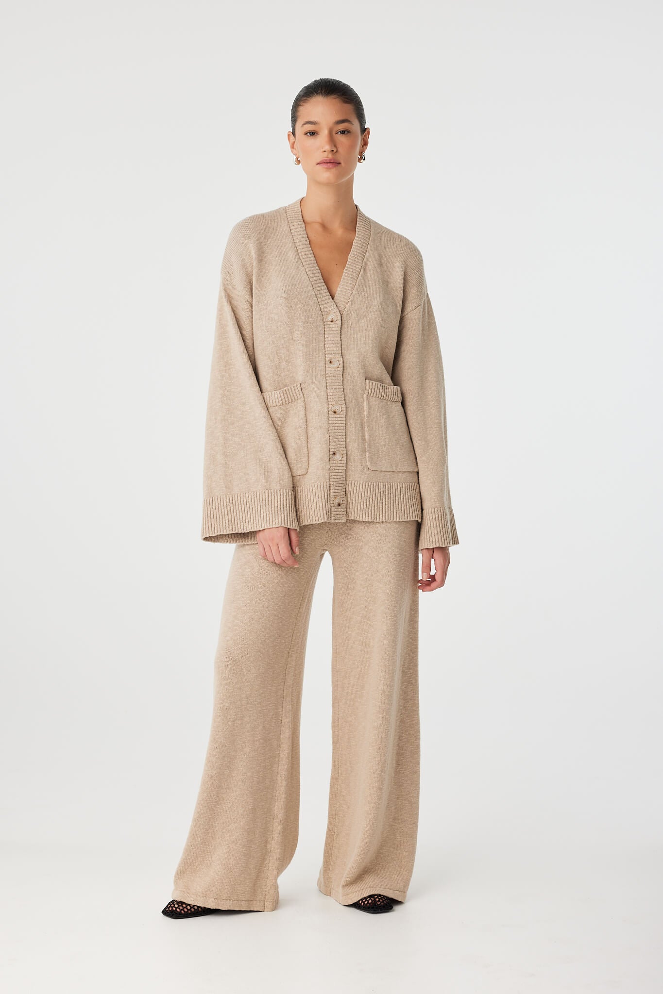 Movement shot of Emmet Cardigan in slub organic cotton, illustrating fluid fit and wide sleeve detail.