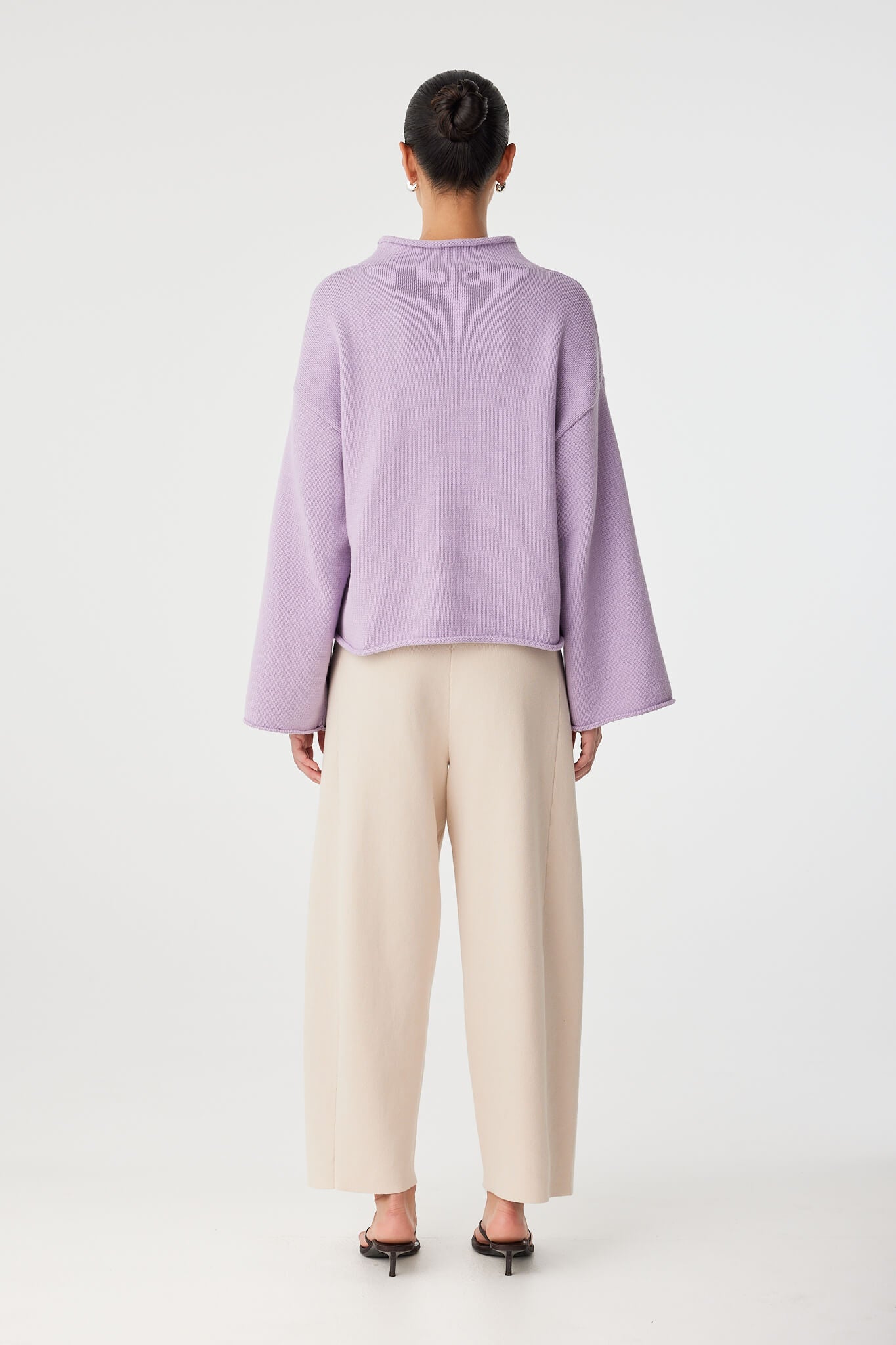 Back view of cropped cotton–merino sweater with dropped shoulders and boxy shape.