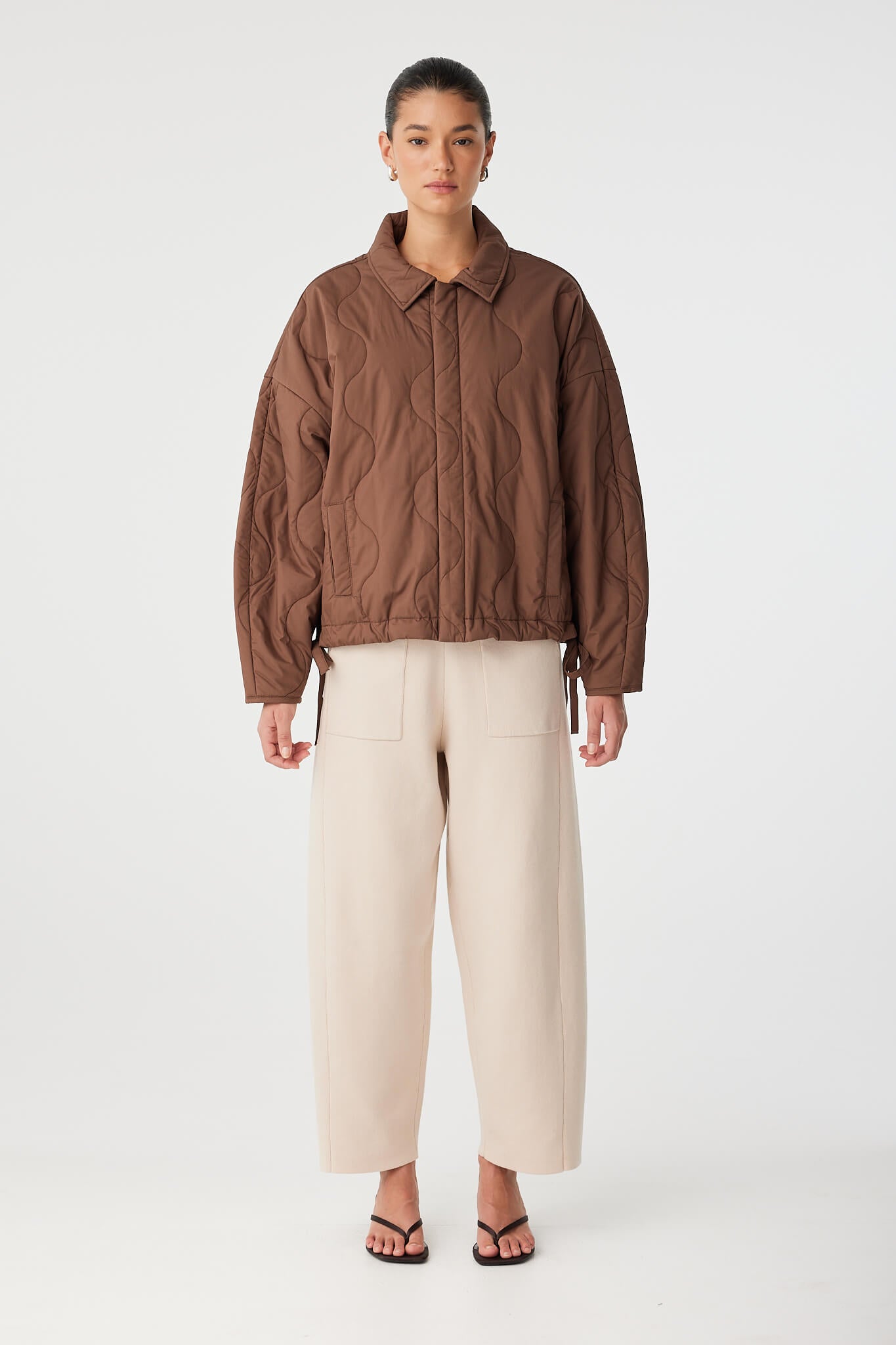 Full-length view of Matteo Jacket in cotton quilt, styled with light trousers.