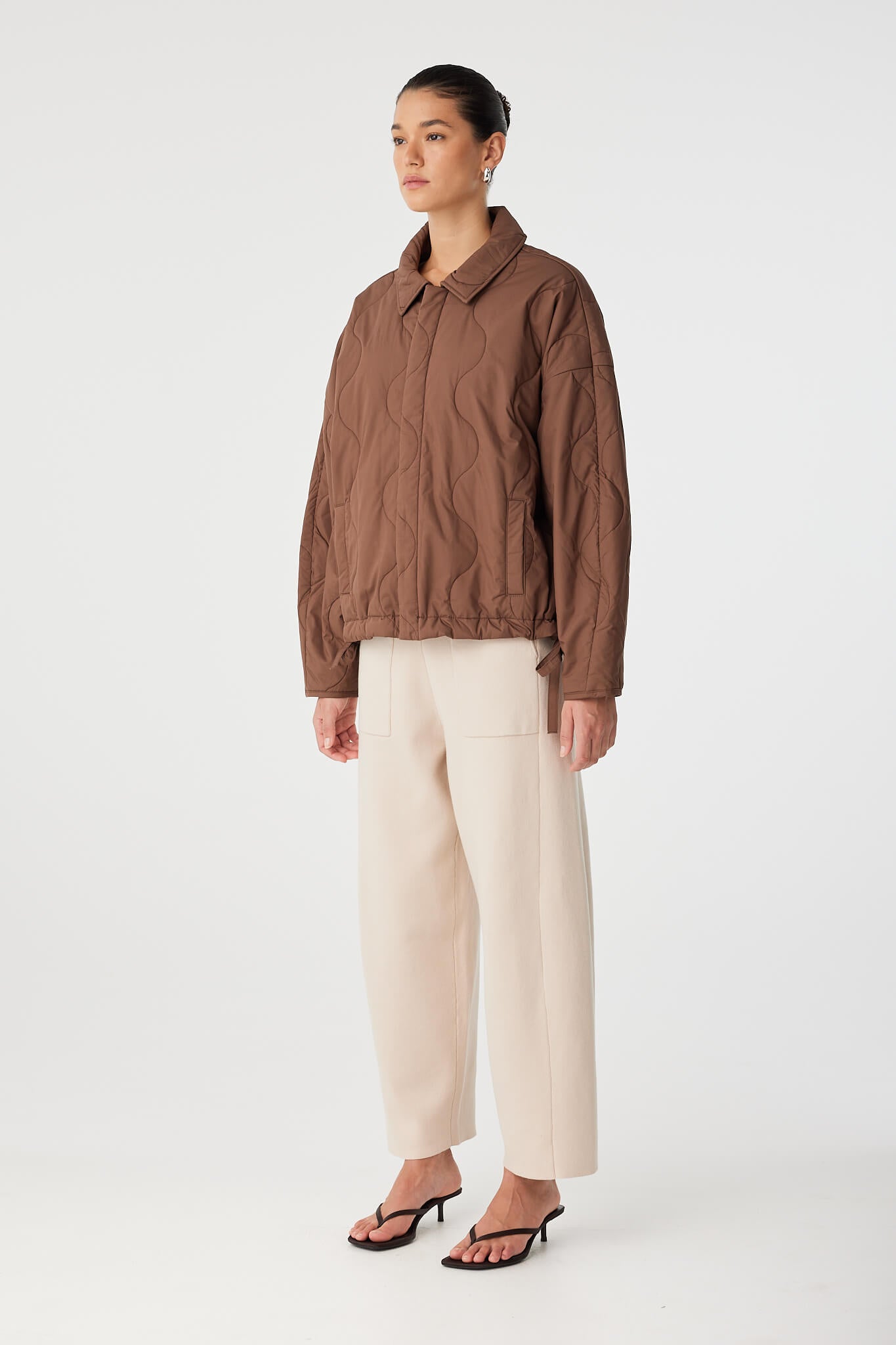 Side profile of cocoon sleeve jacket showing volume and slouchy silhouette.
