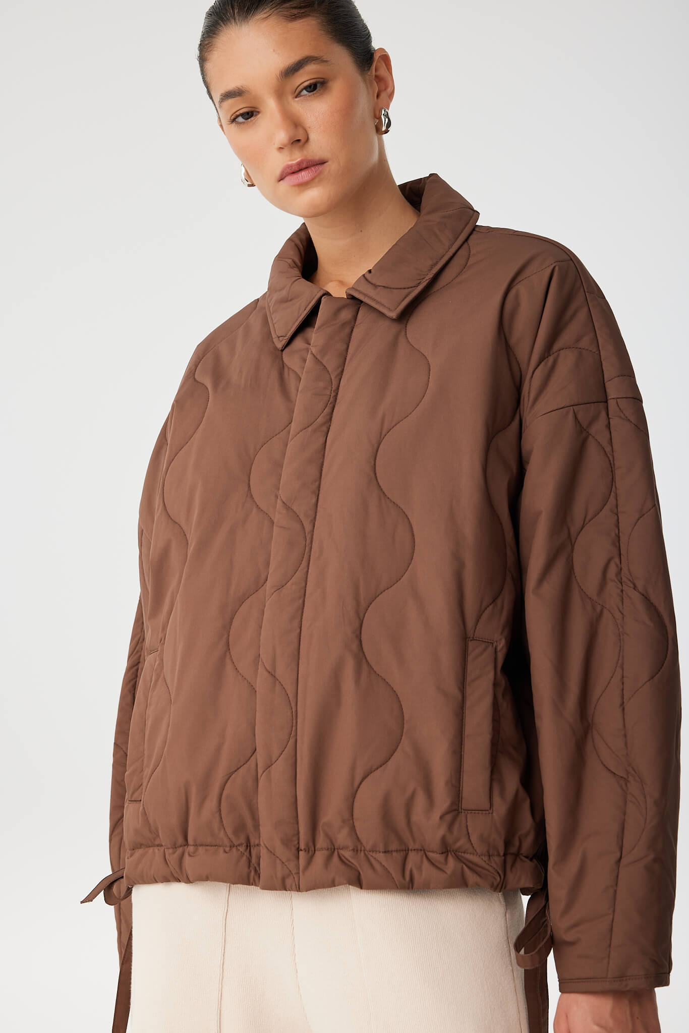 Detail of collar and quilting texture on cotton jacket, relaxed for layering.