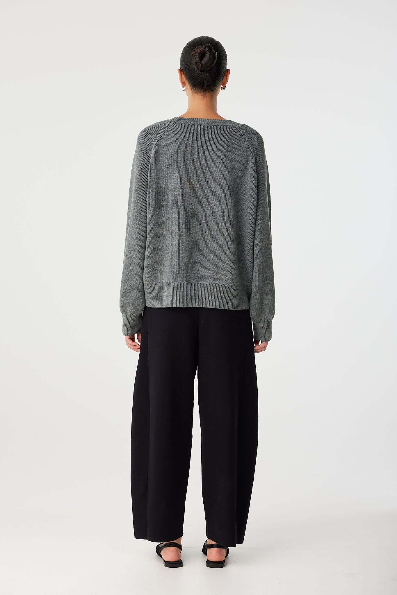 Back view of grey oversized sweater showing relaxed shape and dropped shoulders.