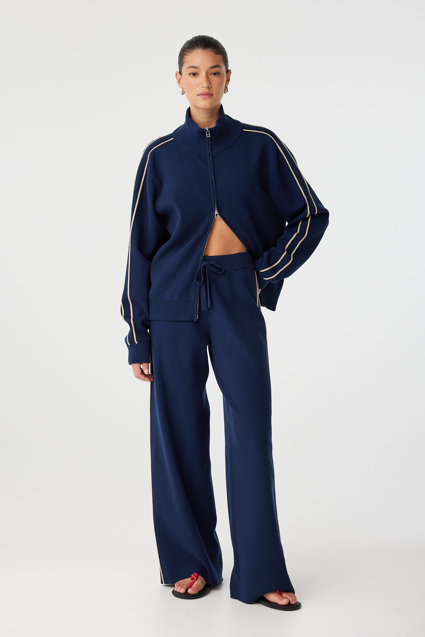 Rome Jacket styled casually with matching pants, showcasing versatility and stripe design.