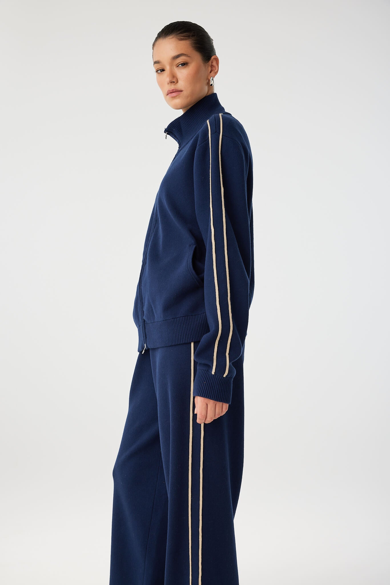 Full side profile of navy pant and coordinating top, showcasing stripe and flow.