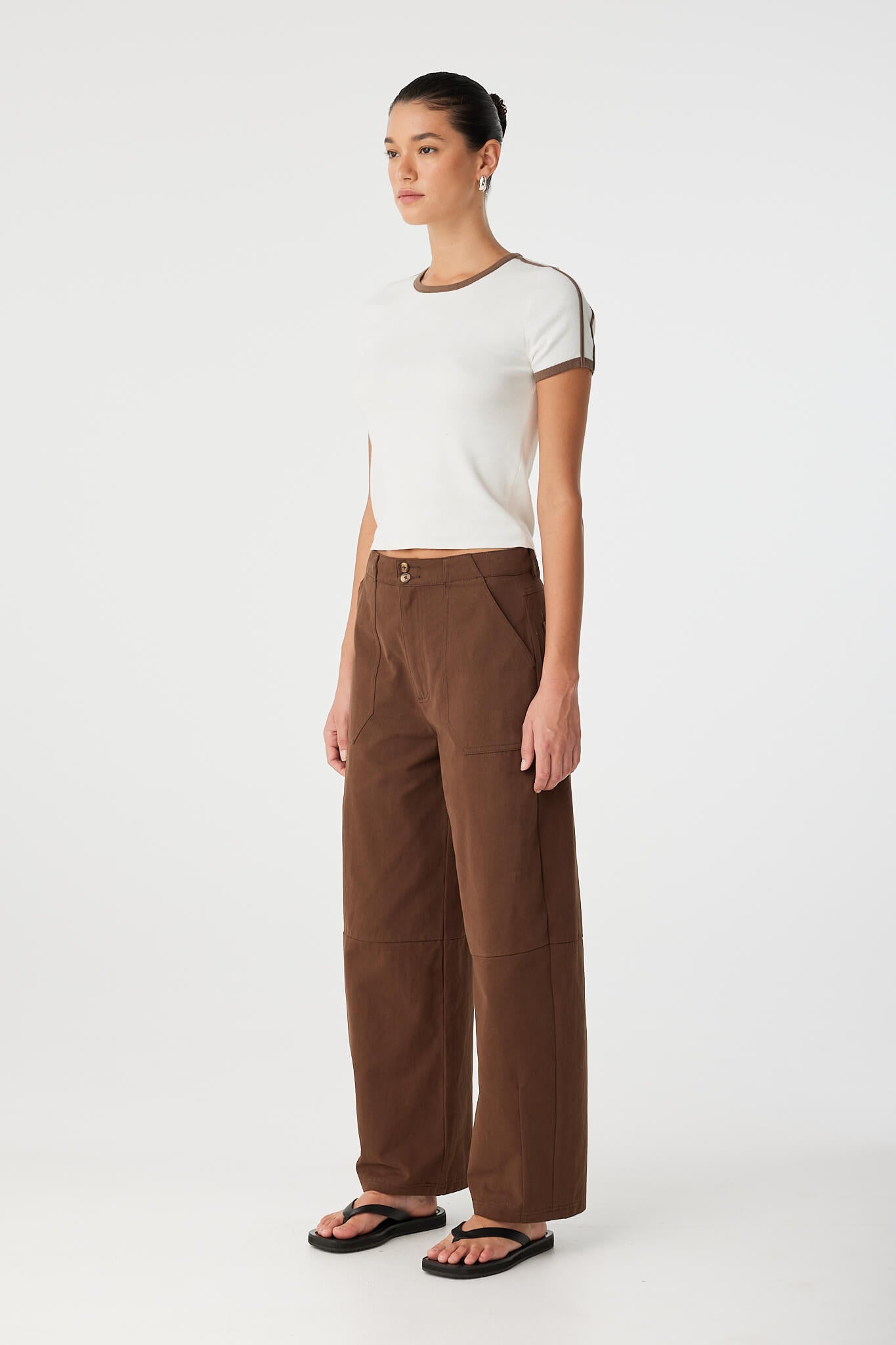 Side angle of fitted cap-sleeve tee showing armhole shaping and stretch cotton knit.