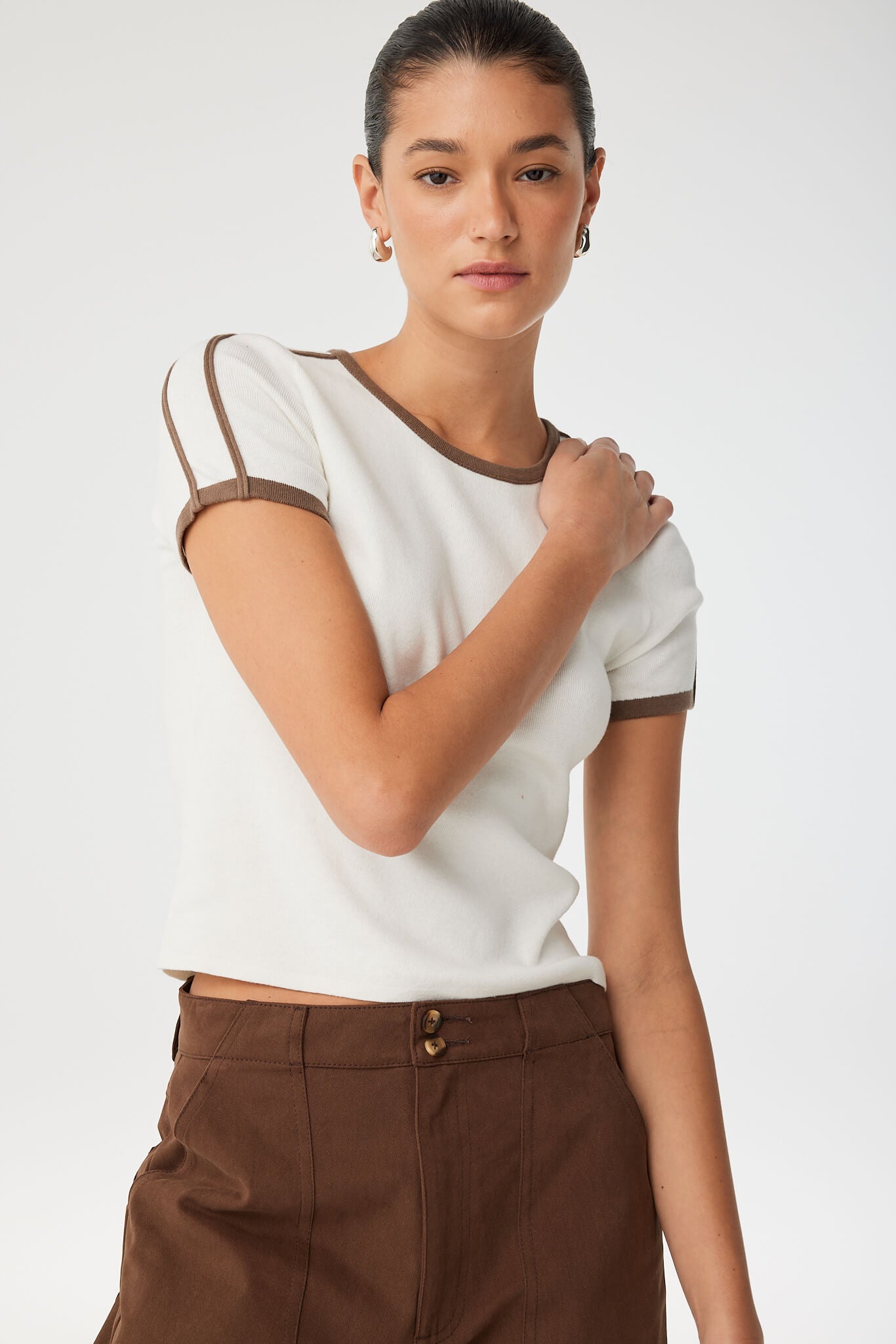 Close-up of fitted tee with crew neckline and sporty arm detailing.