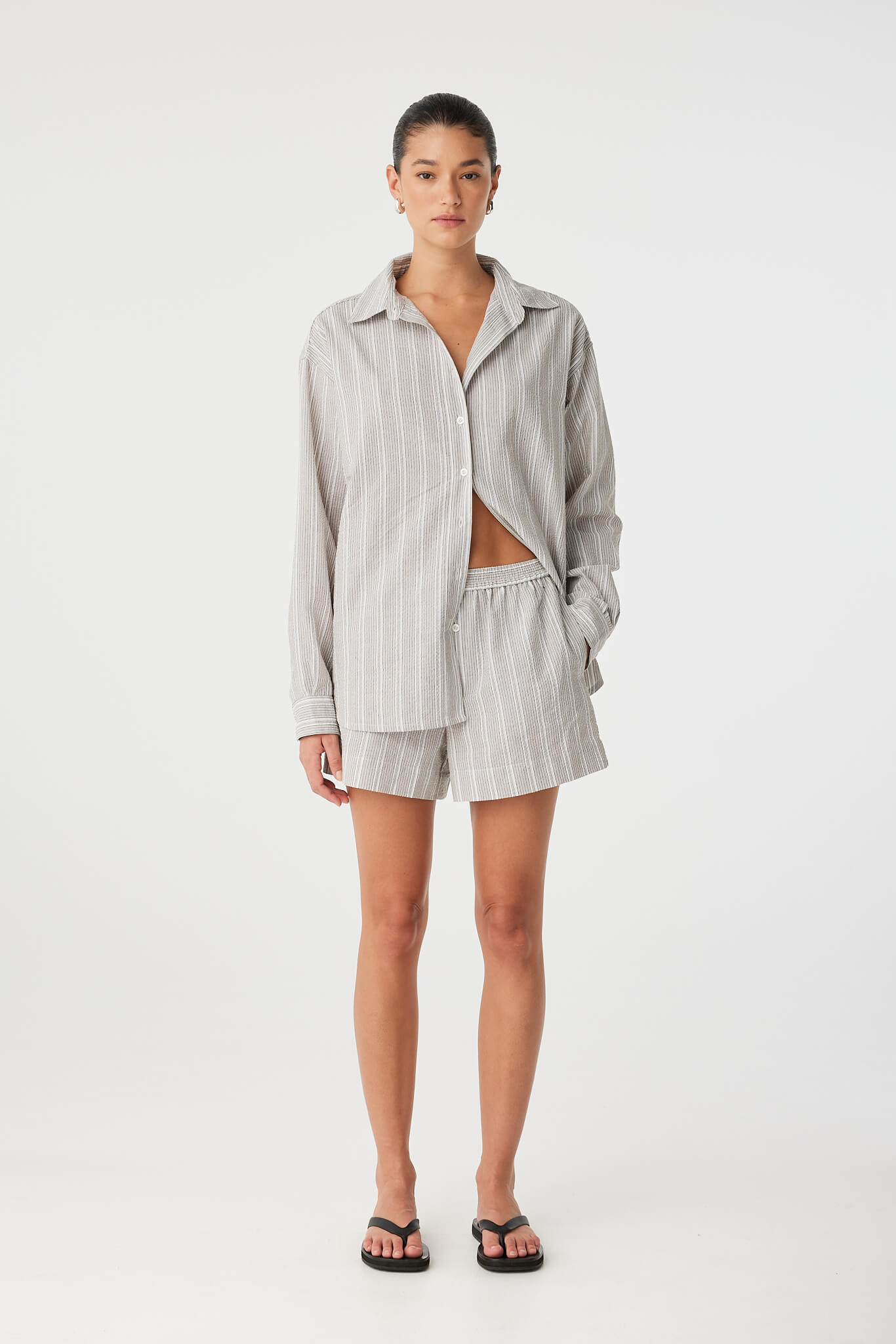 Full-length view of model in coordinated shirt and short set, relaxed fit with ease of movement.