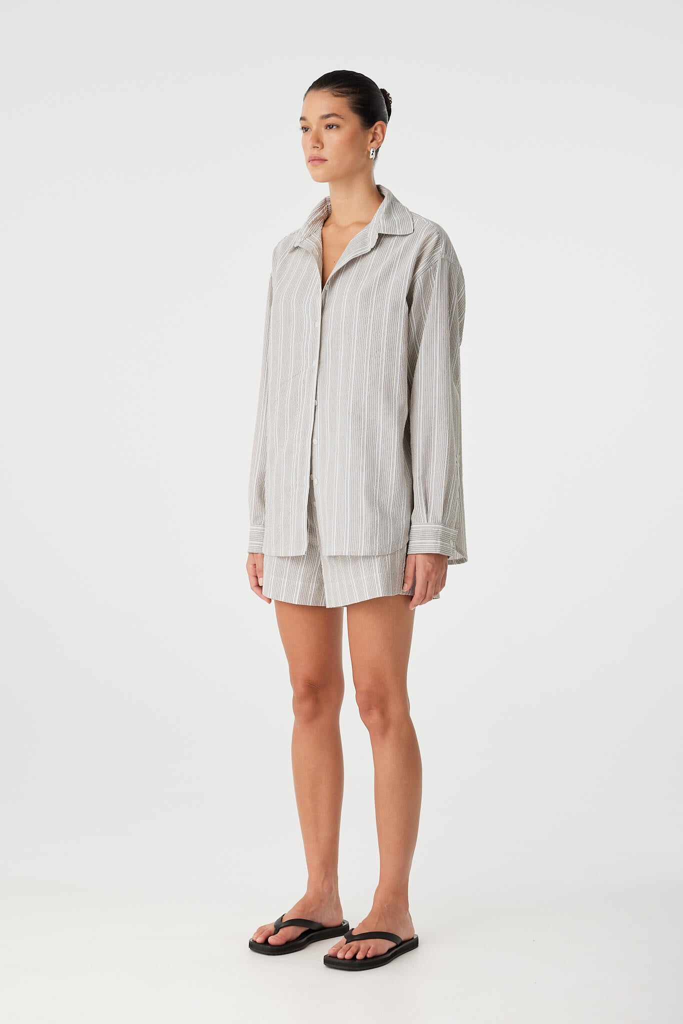 Side detail showing sleeve length and soft structure of textured cotton.