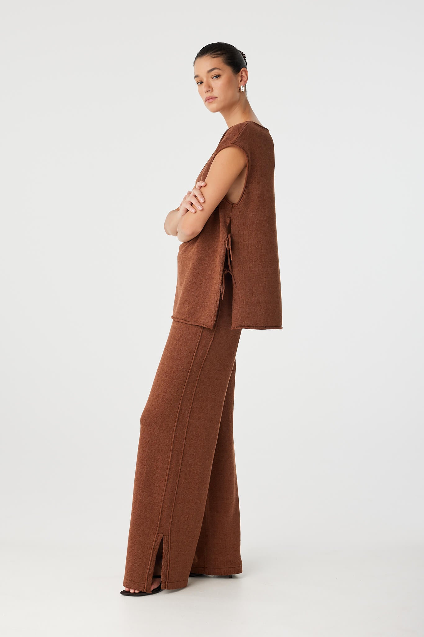 Side view showing tie detail and open split on oversized sleeveless top in clay.