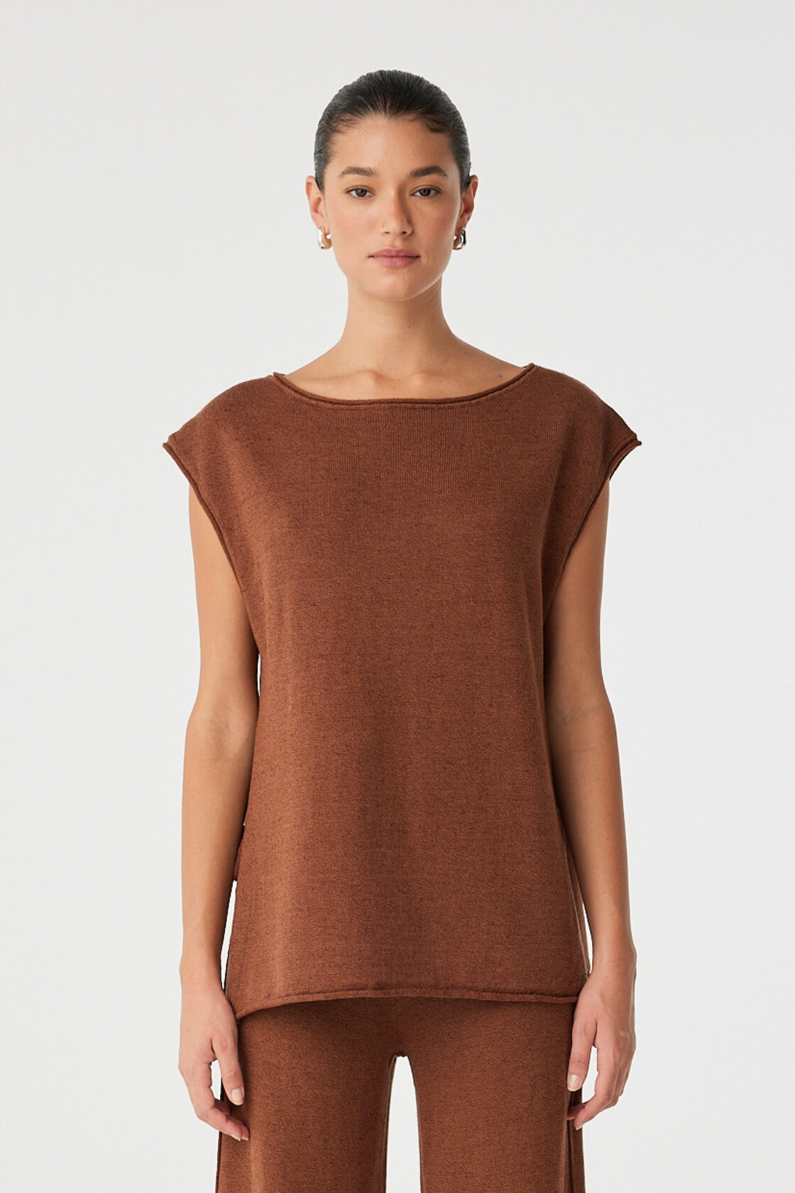 Front view of oversized clay linen–cotton top with tie side splits and rolled neckline.