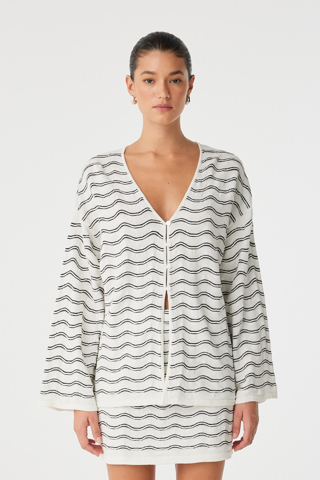 Front view of wave knit button-down top in linen–cotton with V-neck and wide sleeves.