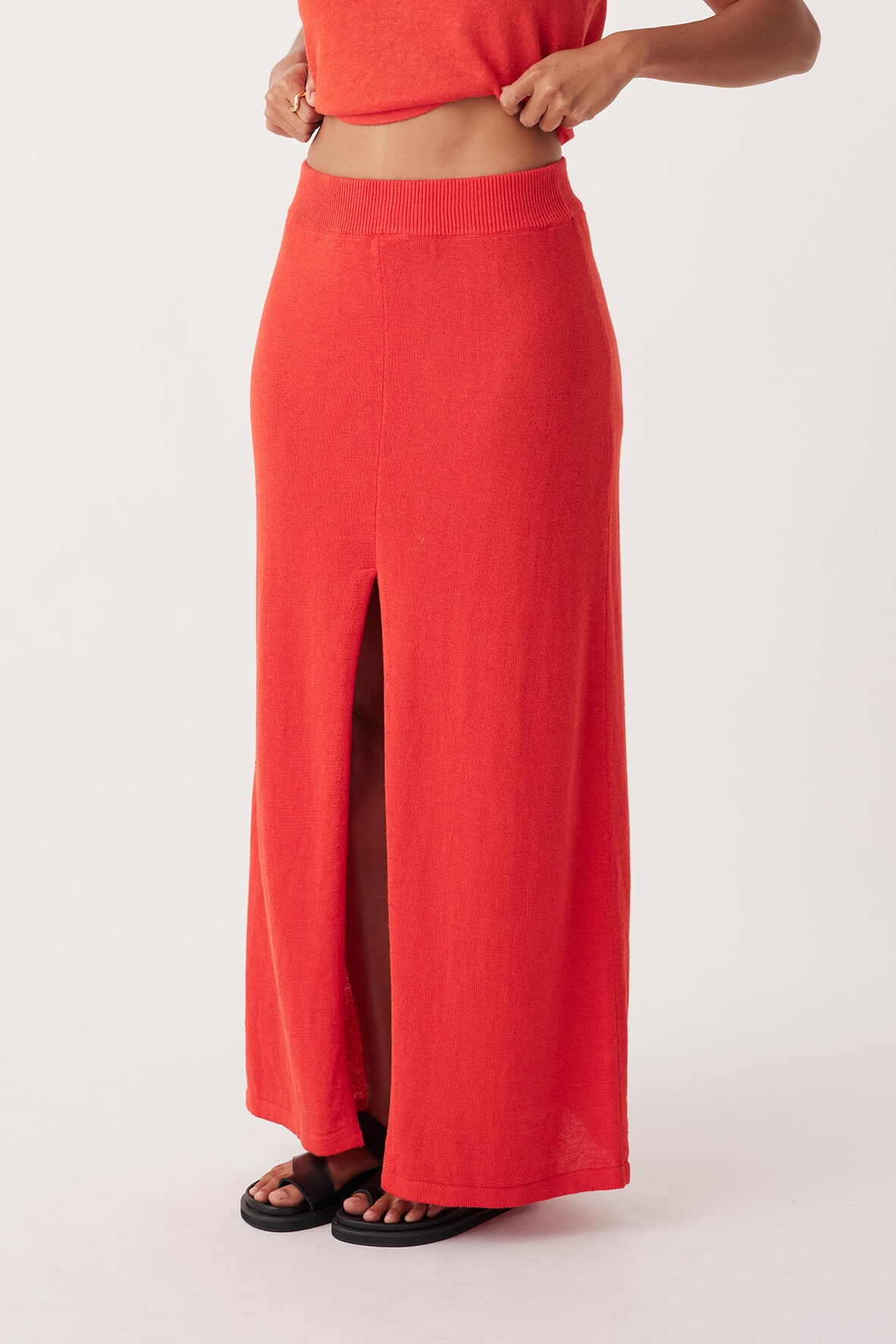 Side view of Poppy Skirt in hibiscus, featuring A-line cut and centre front split in sustainable cotton-linen fabric.
