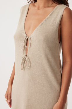 Close-up side view of Poppy Mini Dress in taupe, focusing on tie details and organic cotton-linen blend for sustainable elegance.