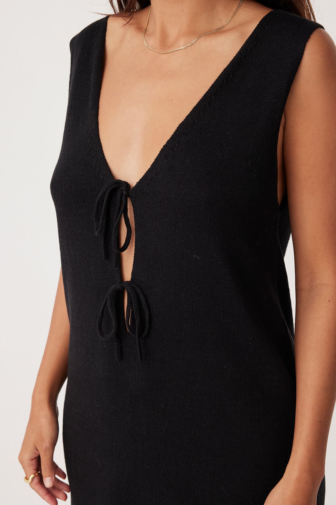 Side view of the Poppy Mini Dress in Black, showcasing its above-the-knee length and eco-friendly material.