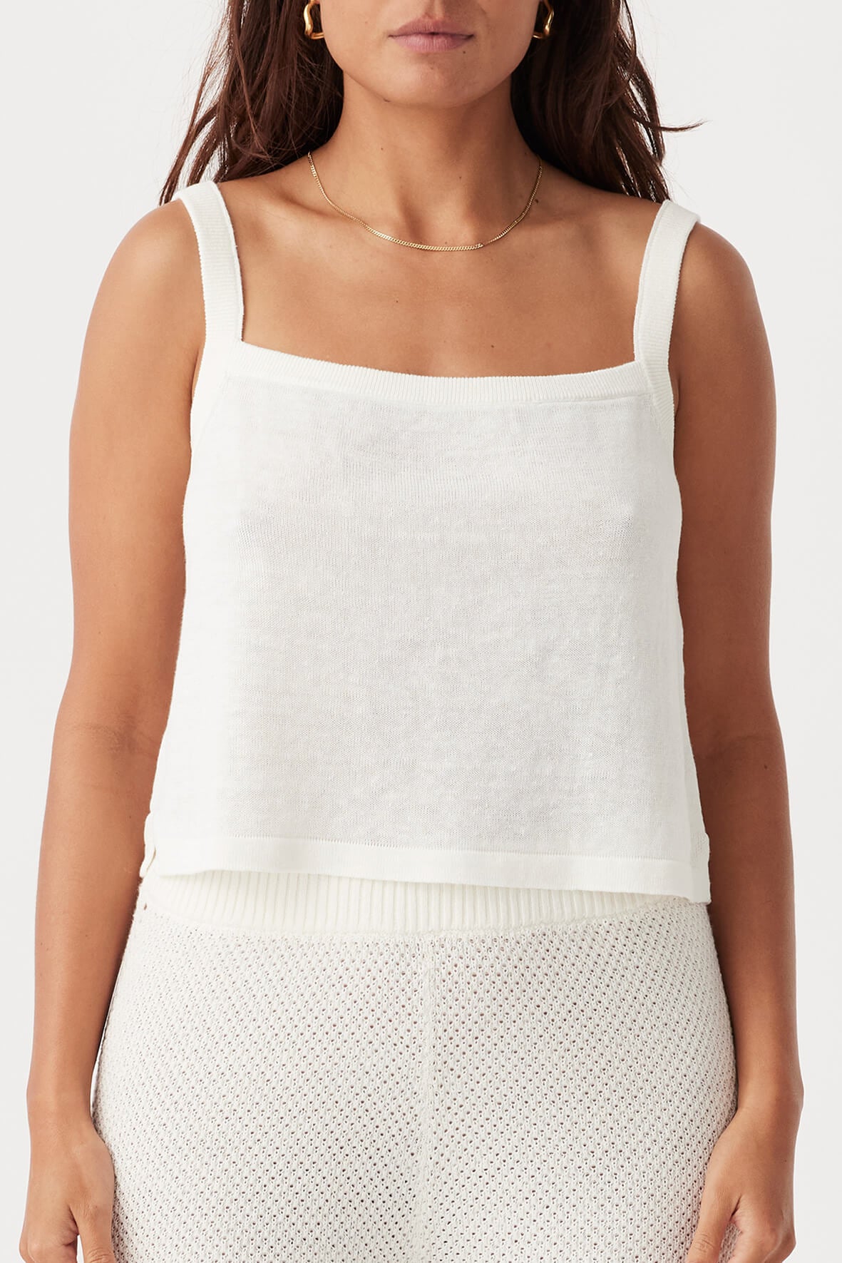 Front view of the Brie Tank in Cream, showcasing its relaxed, cropped fit, square neckline, and ribbed straps, made from breathable 100% linen knit.