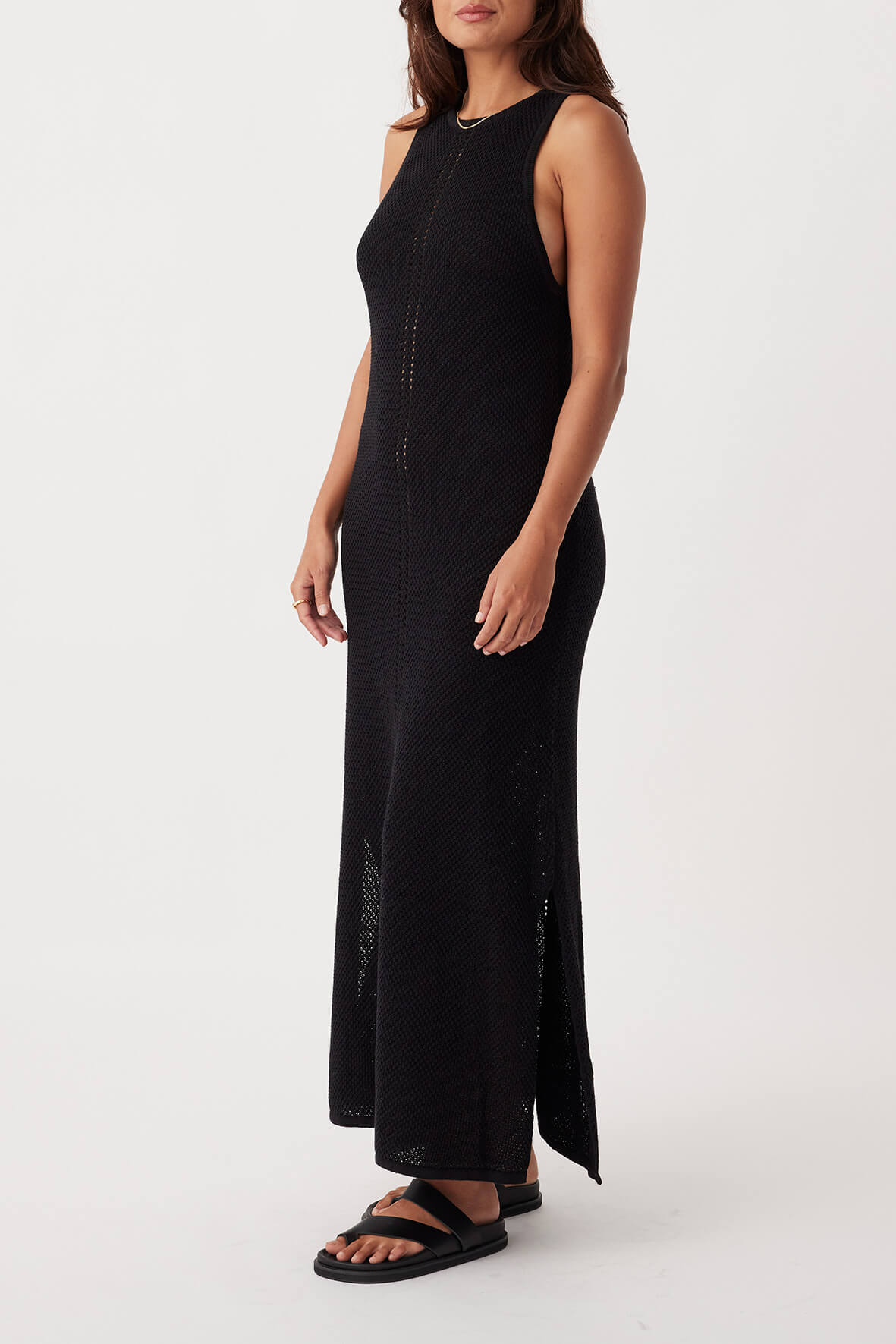 Side view of Sloane Dress in black, showcasing full-length A-line silhouette with high neck and centre front open knit detail.