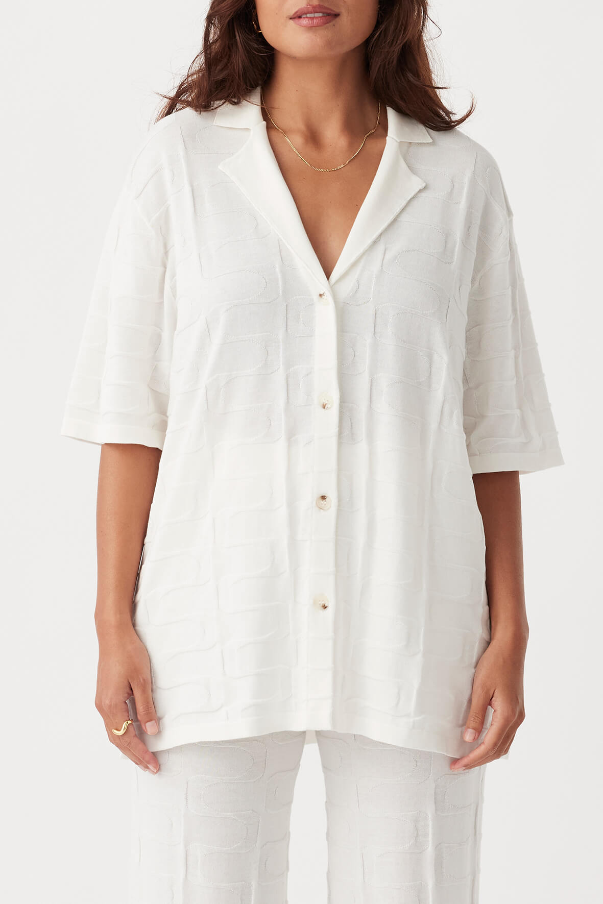 Front view of Lara Shirt in cream, oversized style with button-down front and open collar, made from organic cotton.