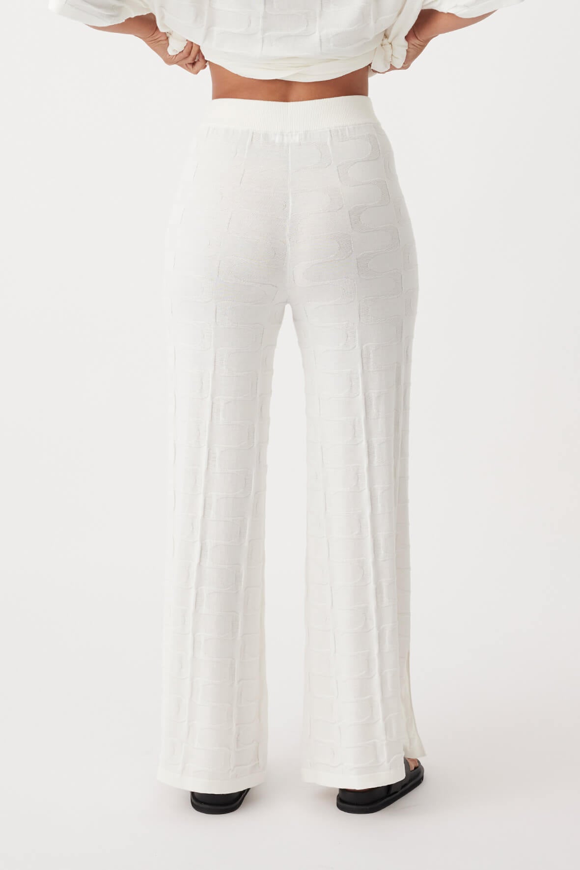 Back view of Lara Pant in cream, ethically produced with wide-leg silhouette and organic cotton patterned knit.
