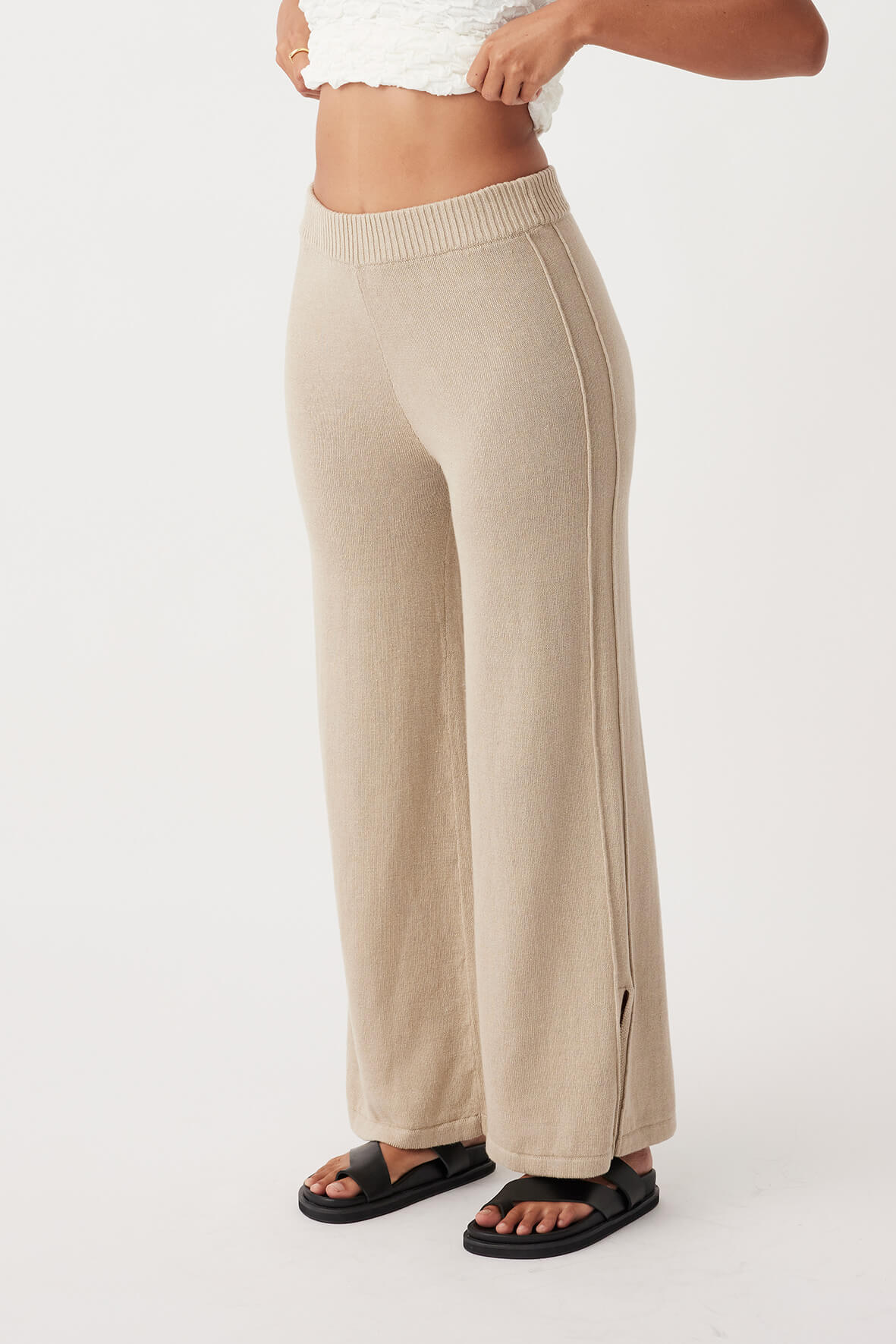 Side view of Poppy Pant, showcasing relaxed fit with pleat details and elastic waist, crafted from sustainable cotton-linen blend