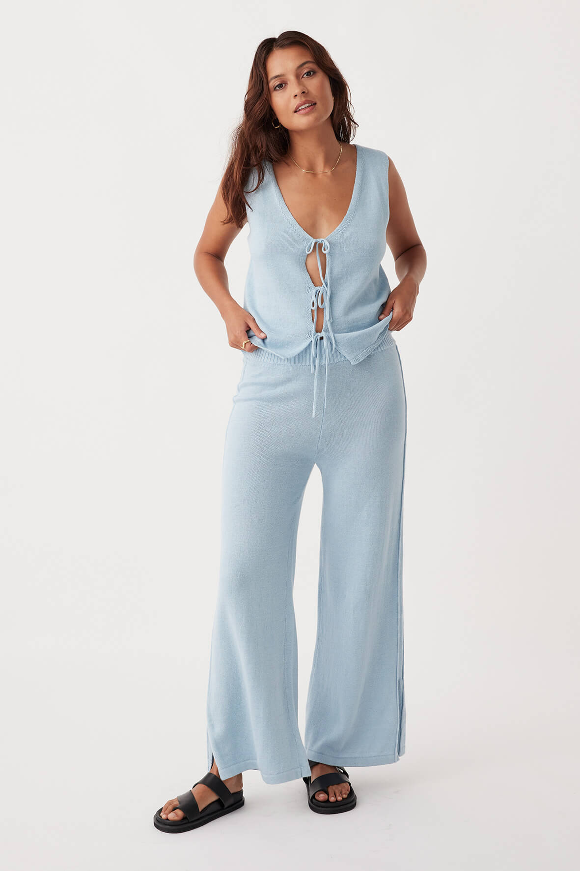 Full-body shot of Poppy Pant in sky, relaxed wide-leg fit with side pleats and ribbed elastic waist, made from organic cotton-linen blend for sustainable style.