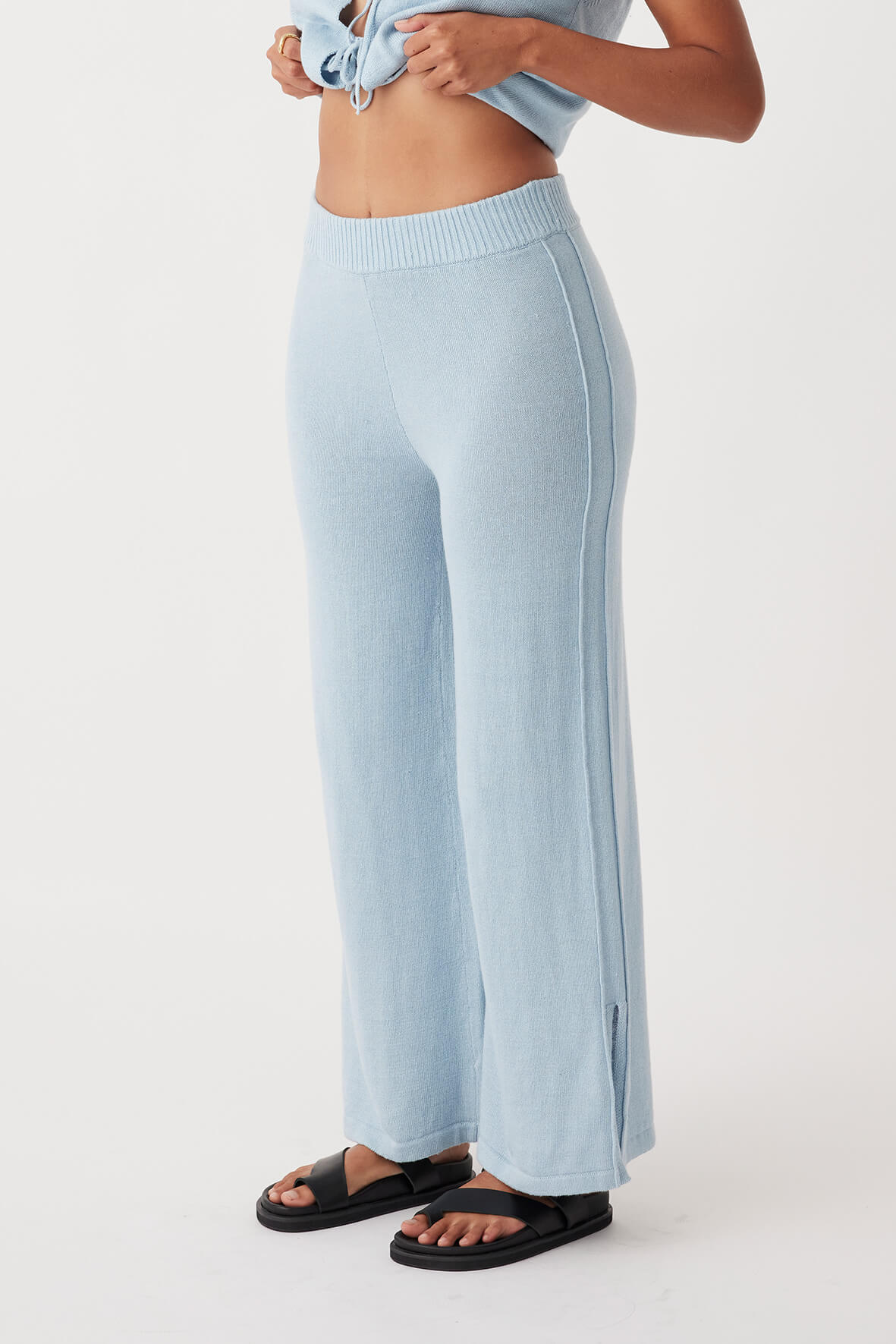 Side view of Poppy Pant in sky, showcasing wide-leg silhouette with pleat details and elastic waist for comfort in sustainable organic cotton-linen fabric