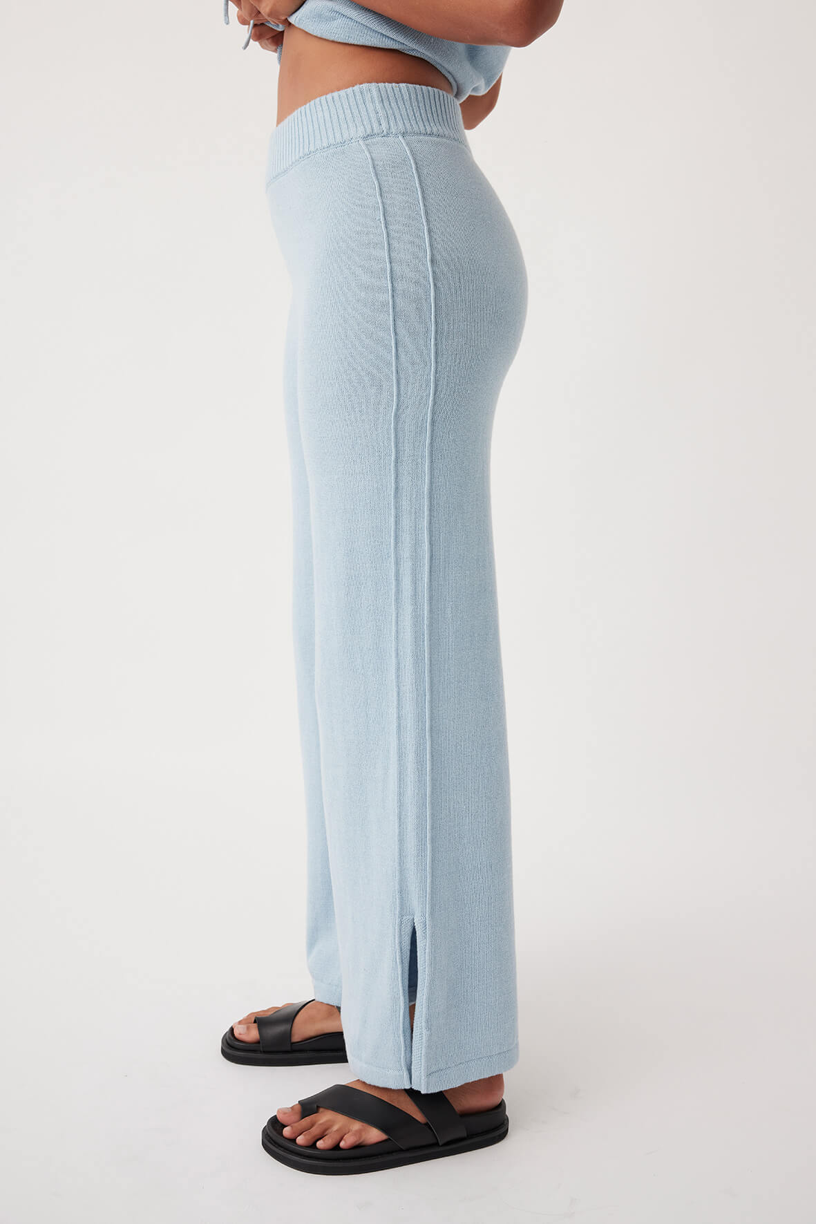  Side view of Poppy Pant in sky, featuring side pleat details and elastic waistband for comfortable, eco-conscious wear.