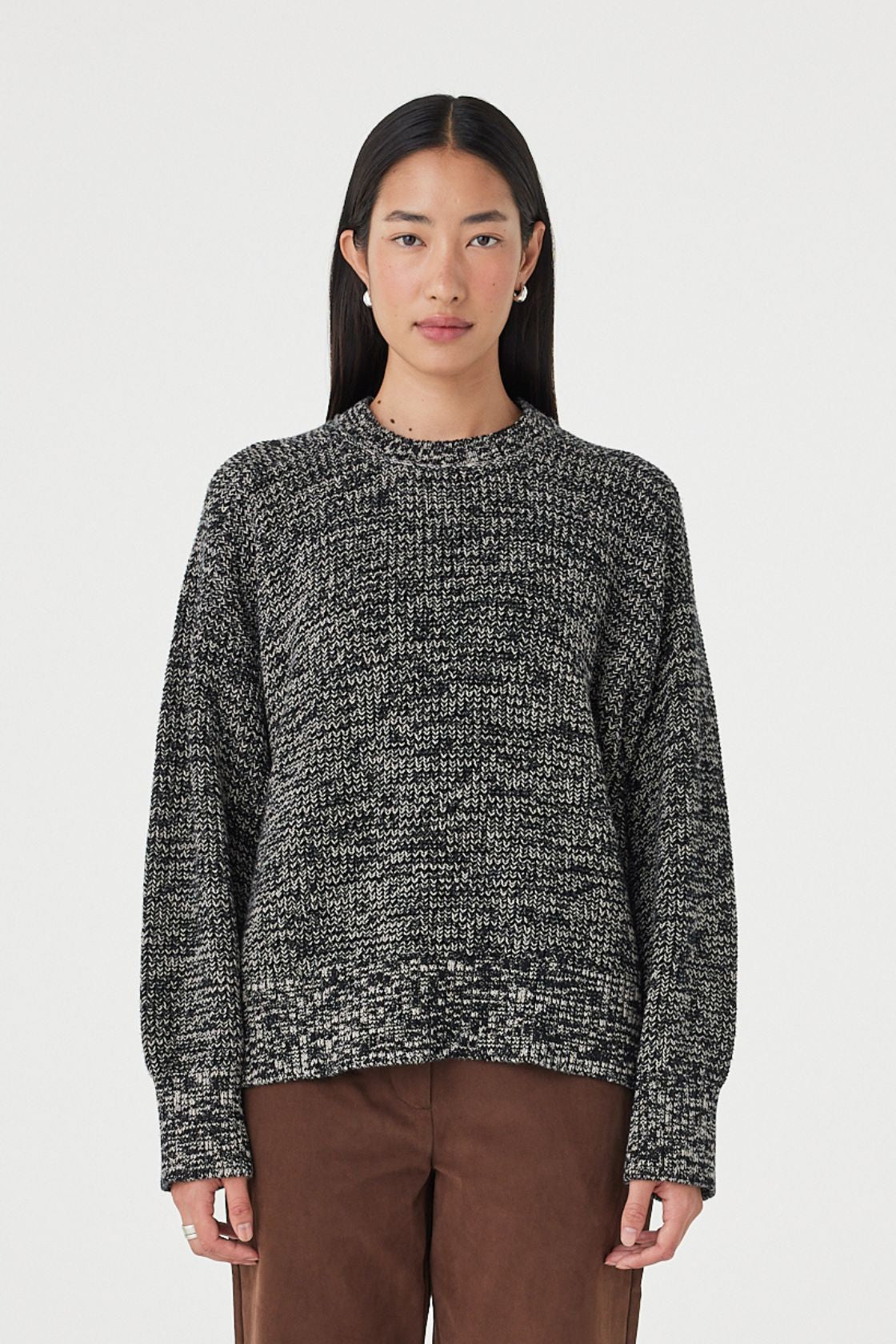 Full-length front view of the Solene Sweater in black and taupe featuring a chunky marled knit texture, oversized silhouette and ribbed hem styled with espresso pants