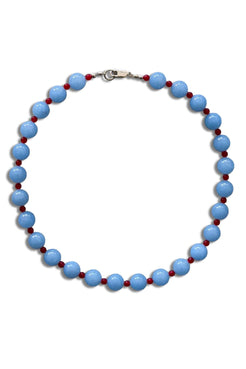 A beaded necklace featuring large light blue oval beads separated by small dark red round beads, with a silver lobster clasp at the top, shown on a plain white background.
