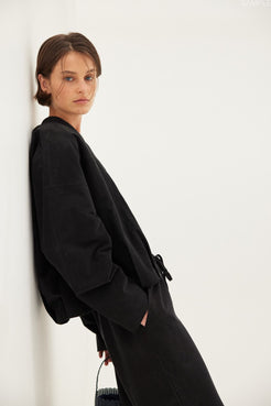 Lifestyle angle: Rae Pant black, cupro–rayon drapey pants showing movement and soft fall.