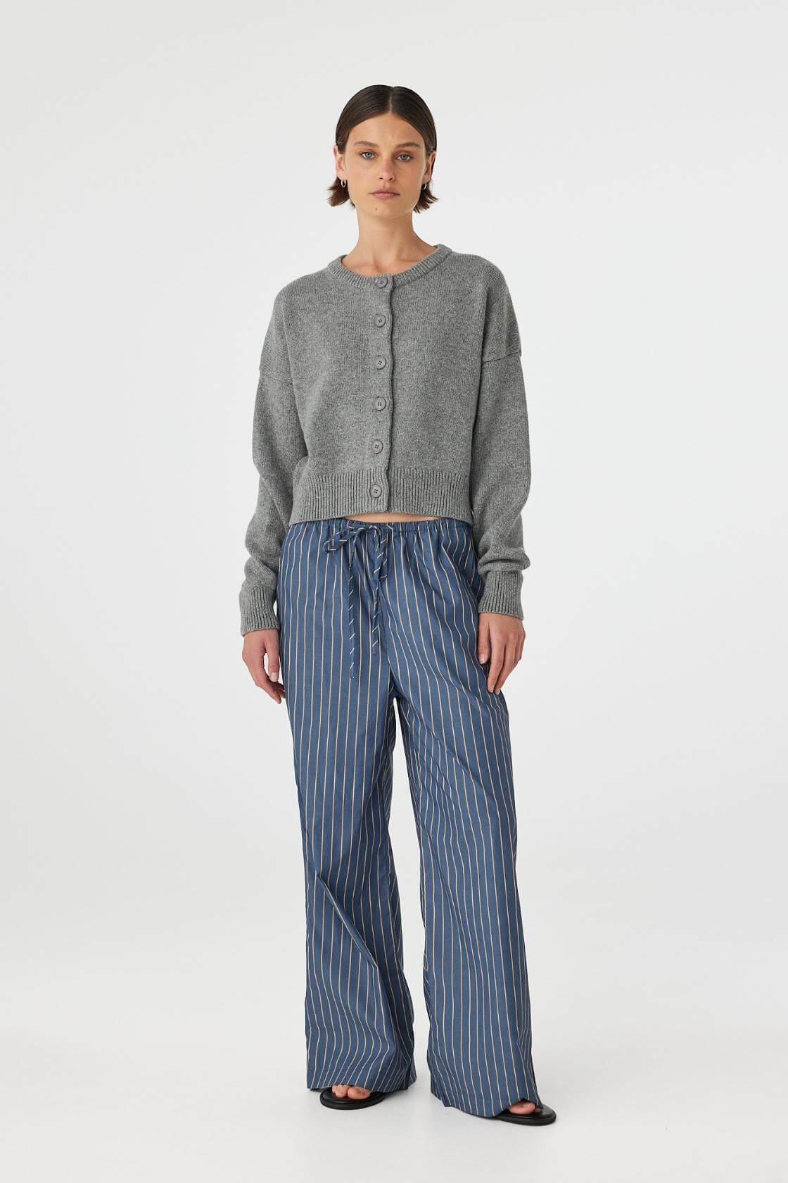 Model wearing Rae Pant in muted blue stripe, 100% cotton straight-leg pants with elastic drawcord waist, full front view.