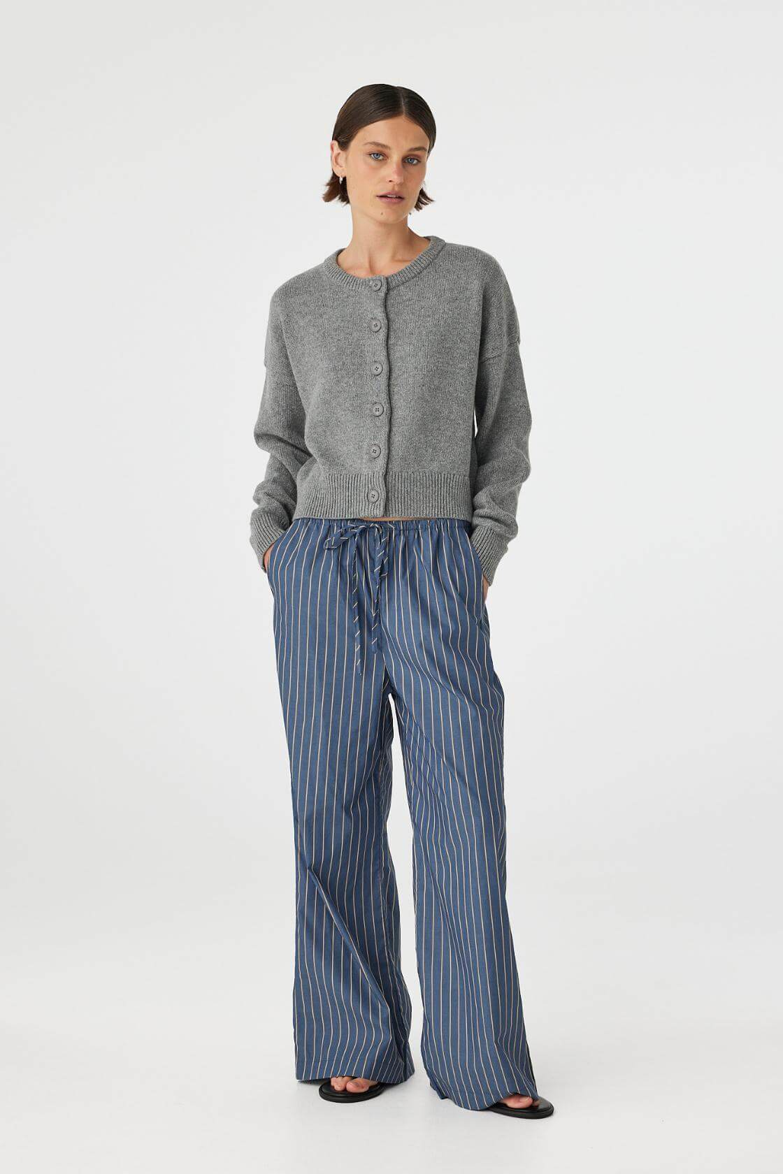 Angled side view of Rae Pant muted blue stripe, full length cotton straight-leg pants showing leg line and drape.