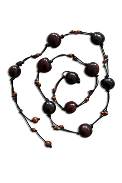 A dark brown beaded belt with large polished round beads and smaller reddish-brown accent beads, arranged in a spiral on a white background.