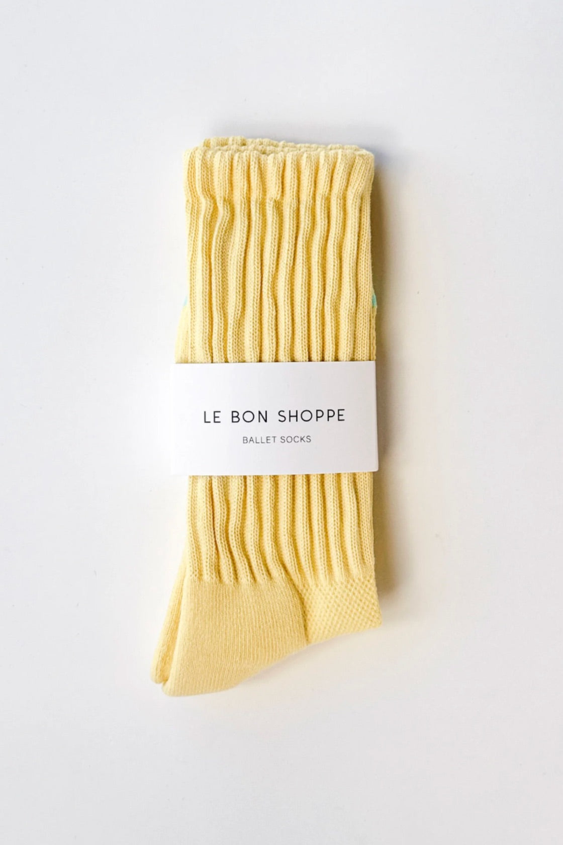 Pack of yellow ballet socks with 'Le Bon Shoppe' label on a white background