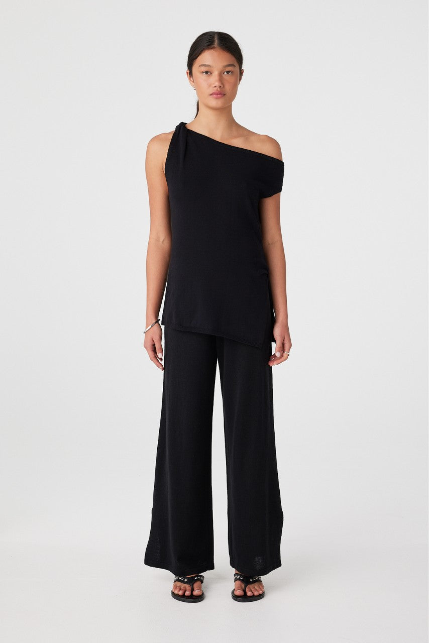 Front view of model wearing black relaxed wide-leg linen organic cotton pants with one-shoulder top