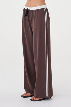 Close-up side view of the Tully Pant in espresso highlighting the organic cotton knit texture, contrast double stripe detail and relaxed straight wide-leg shape