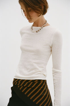 Close detail of Aston Top cream, semi-sheer knit texture with boat neckline and long sleeve.
