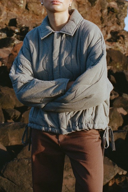 Close-up of blue-check quilted jacket worn outdoors