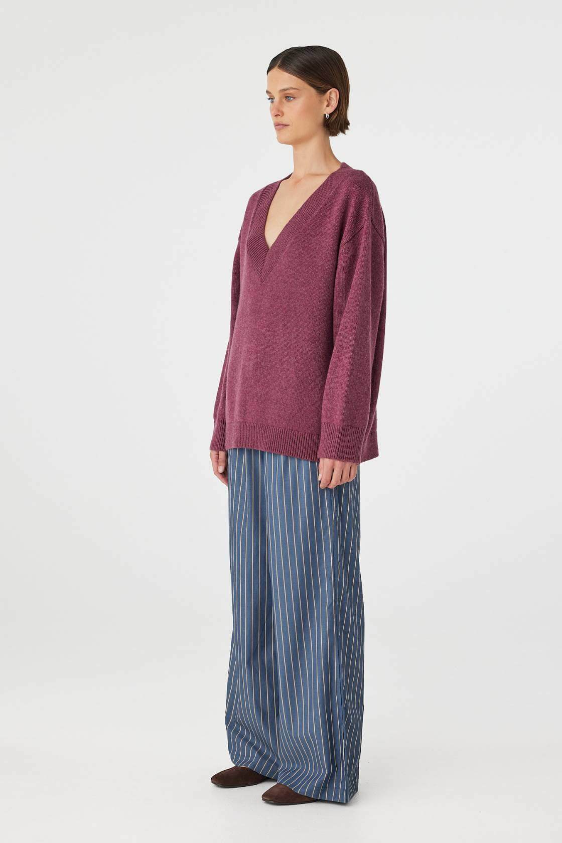 Side view of merlot sweater showing dropped shoulder and relaxed fit