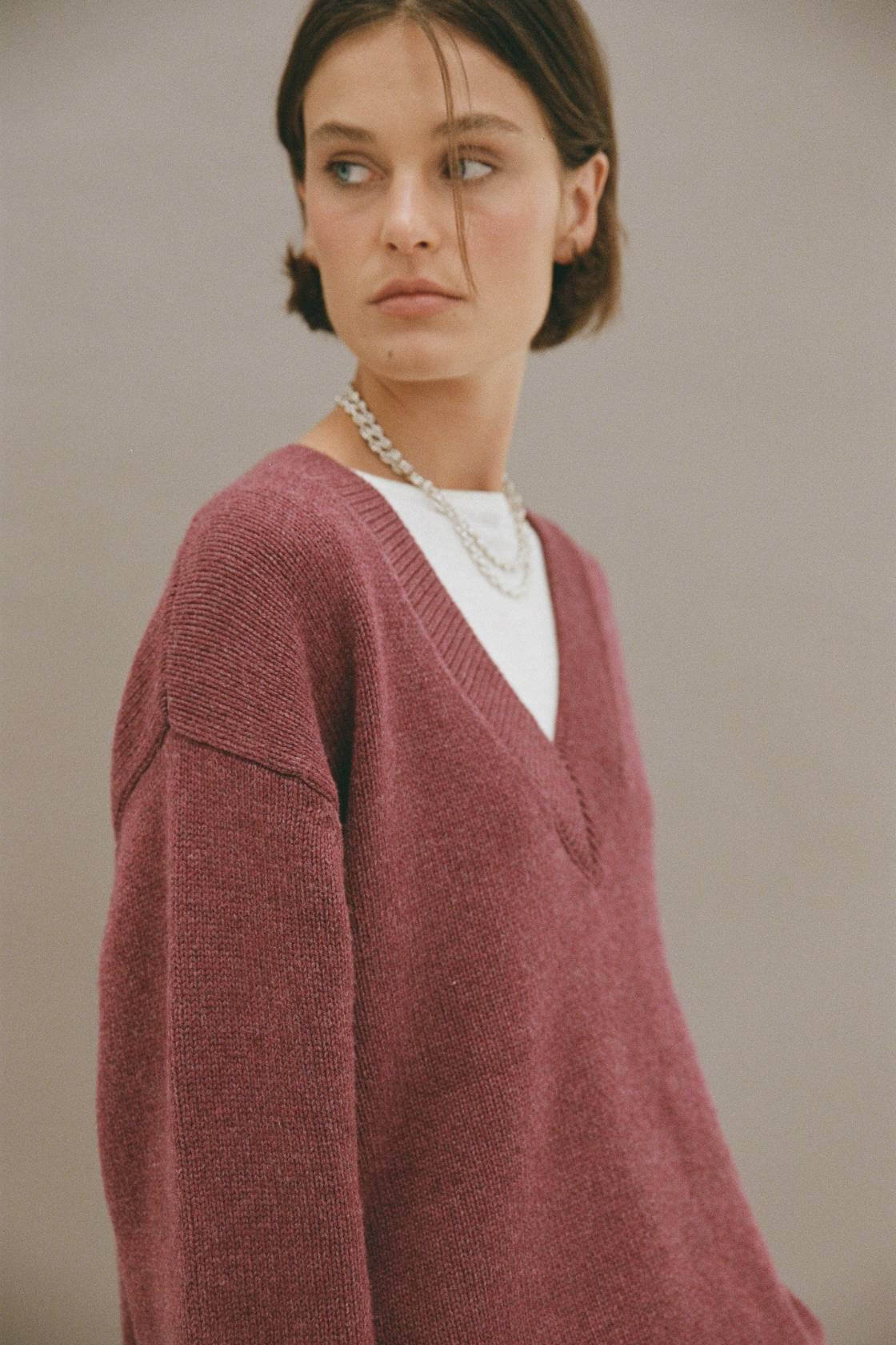 Close-up front view of merlot marble sweater with deep V-neckline