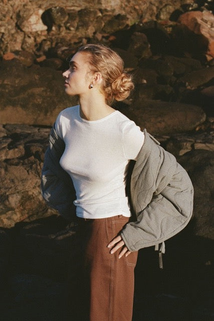 Cream top worn outdoors with layered styling