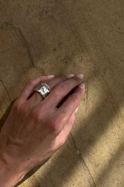 Close-up of recycled sterling silver statement ring with heavy, sculptural band and melted finish.