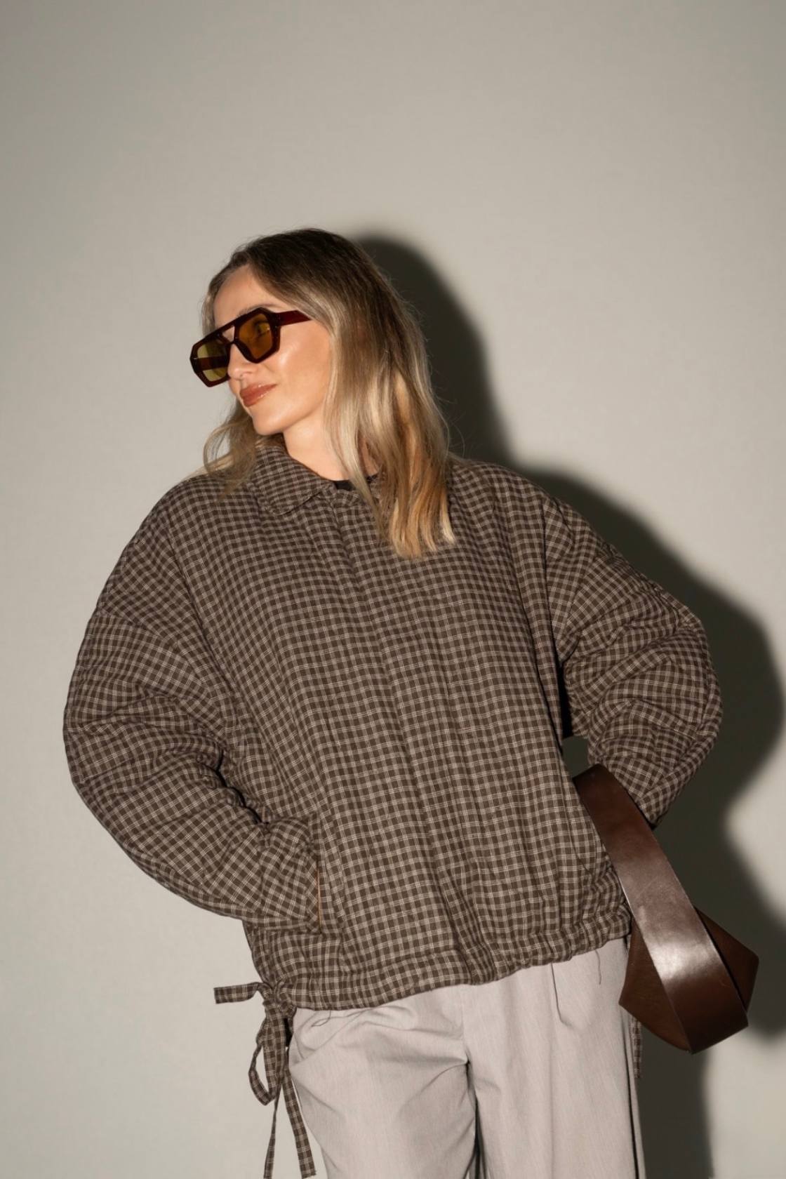 Espresso check jacket with relaxed, boxy fit styled with neutral pants