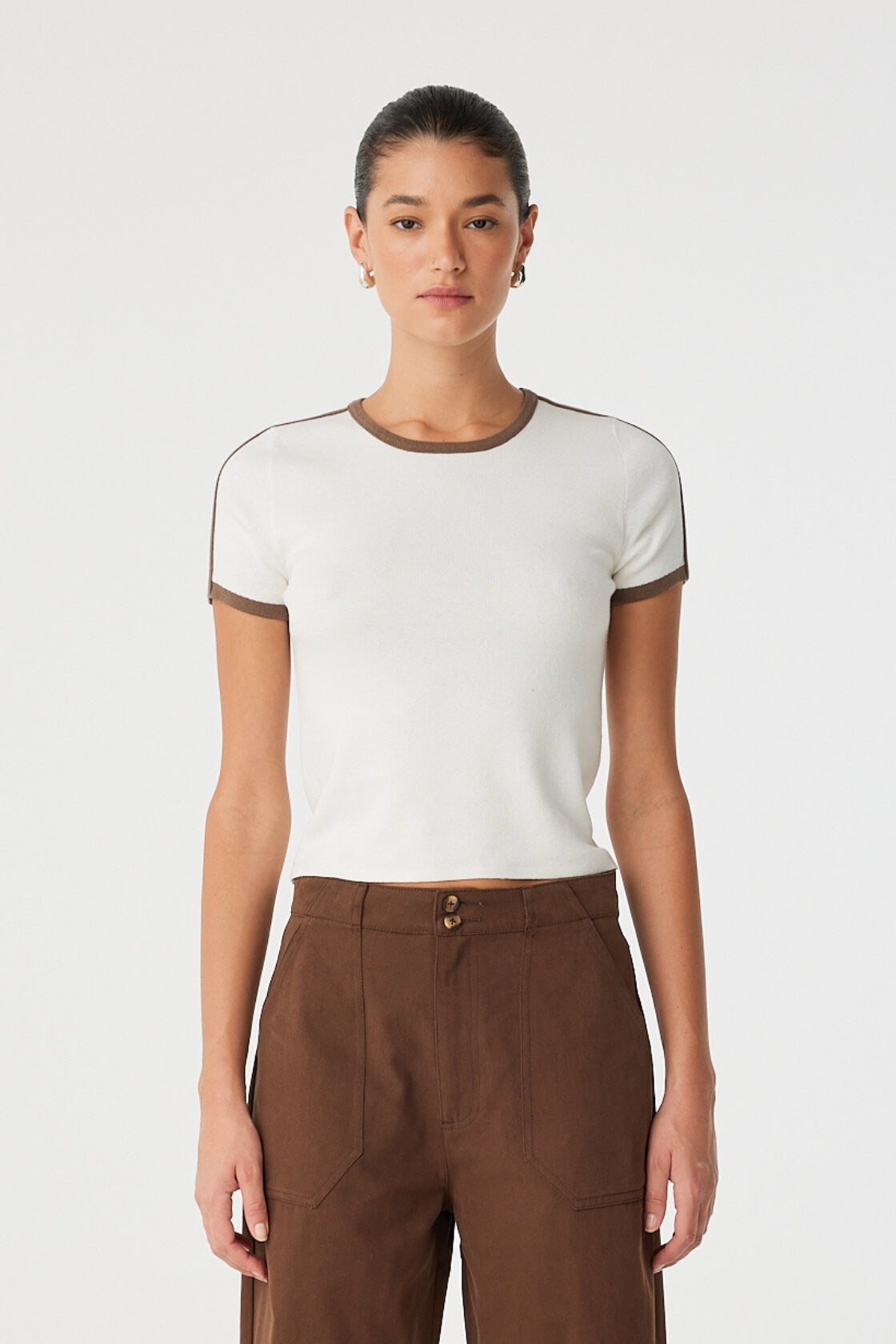 Model wears cream ringer tee with cacao contrast stripe on cap sleeves and crew neckline.
