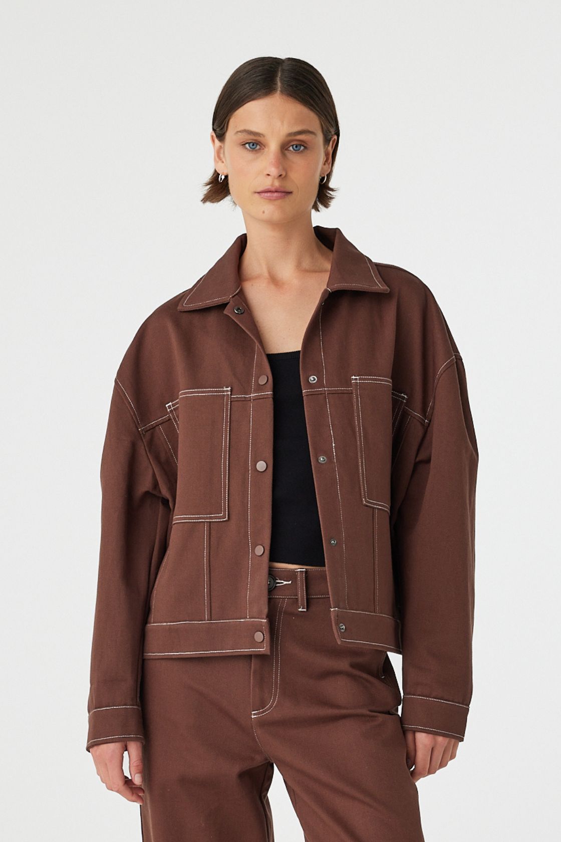 Front view of brown cropped jacket with contrast stitching