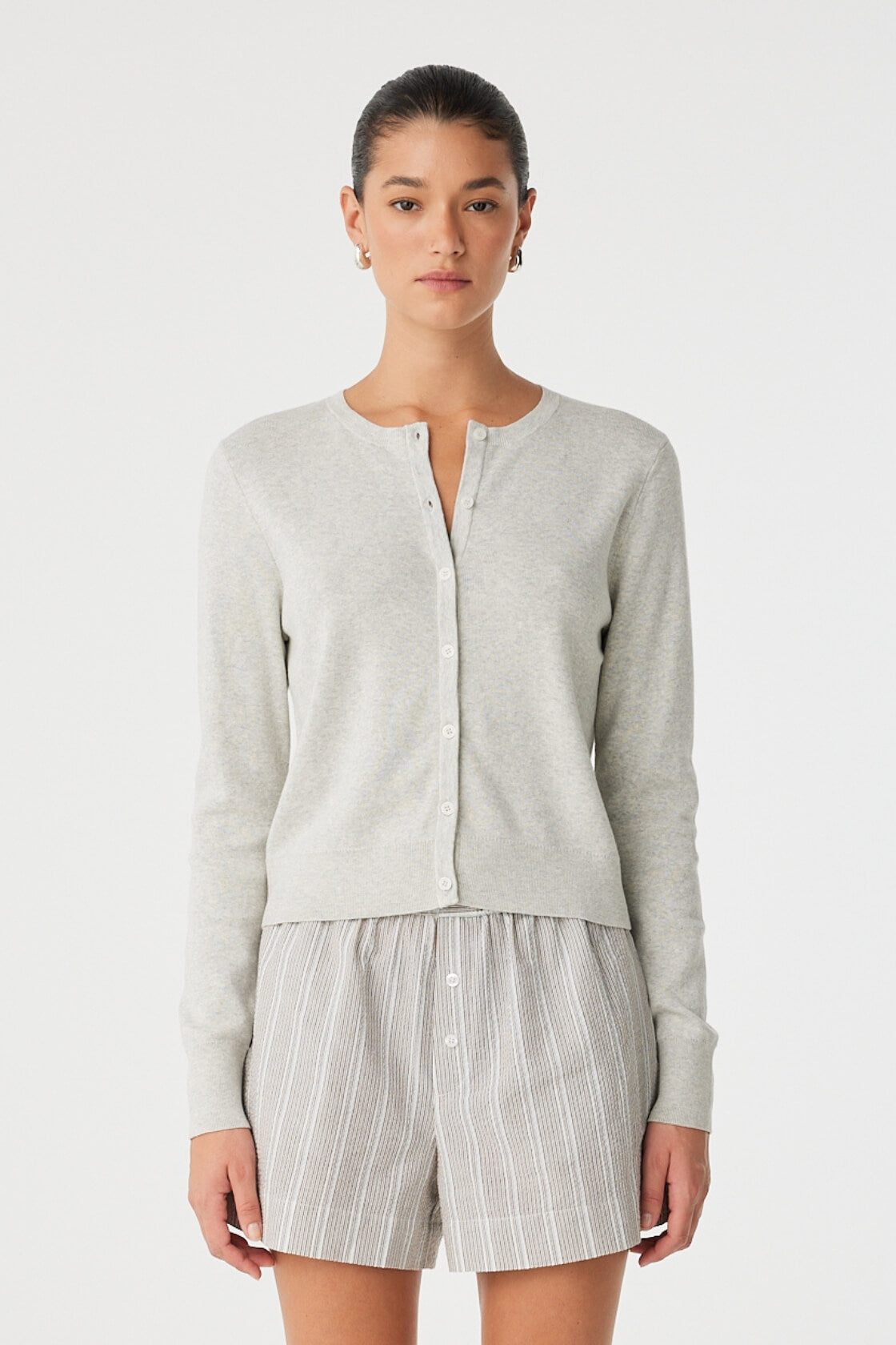 Front view of cropped grey cardigan in smooth organic cotton, crew neckline, and clean button closure.