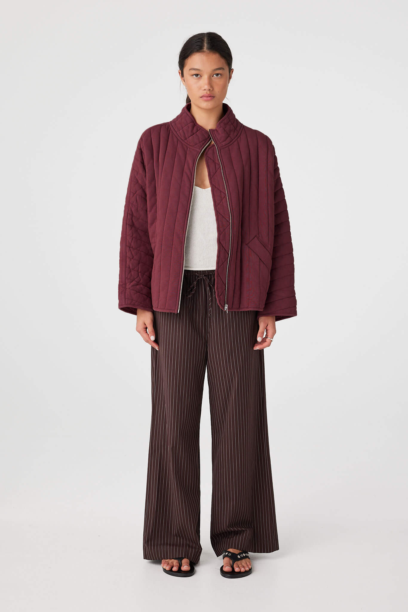 Front view of Merlot quilted jacket showing high neckline, zip front and quilted texture