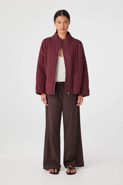 Front view of Merlot quilted jacket showing high neckline, zip front and quilted texture